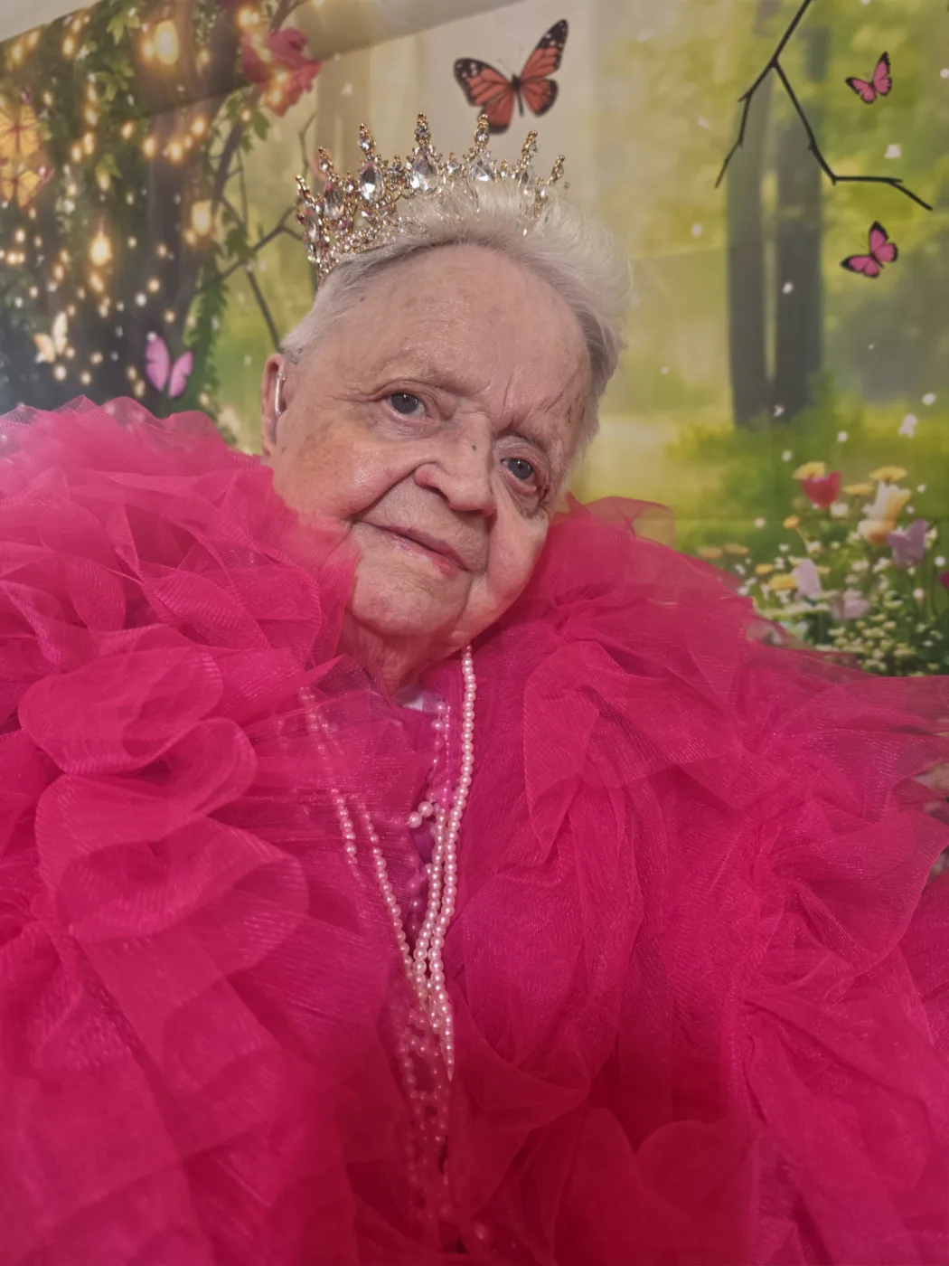 A resident at Parklands Care Home in Alloa in a crown, pearls and a pink gown during the Queen for the Day photoshoot