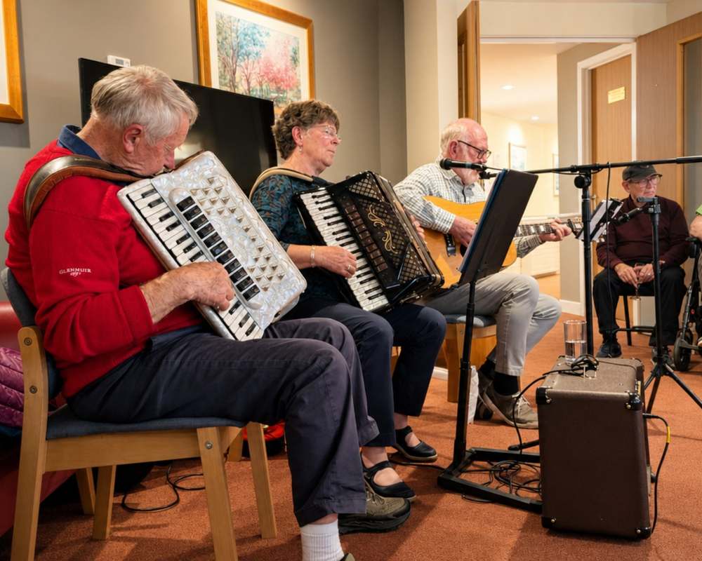 Residents listening to live accordion music in the lounge at Redwoods Care Home in Alness