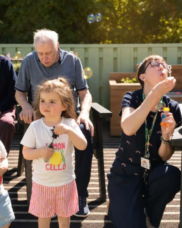 Residents, families and children enjoying a summer garden party at St Olaf Care Home in Nairn