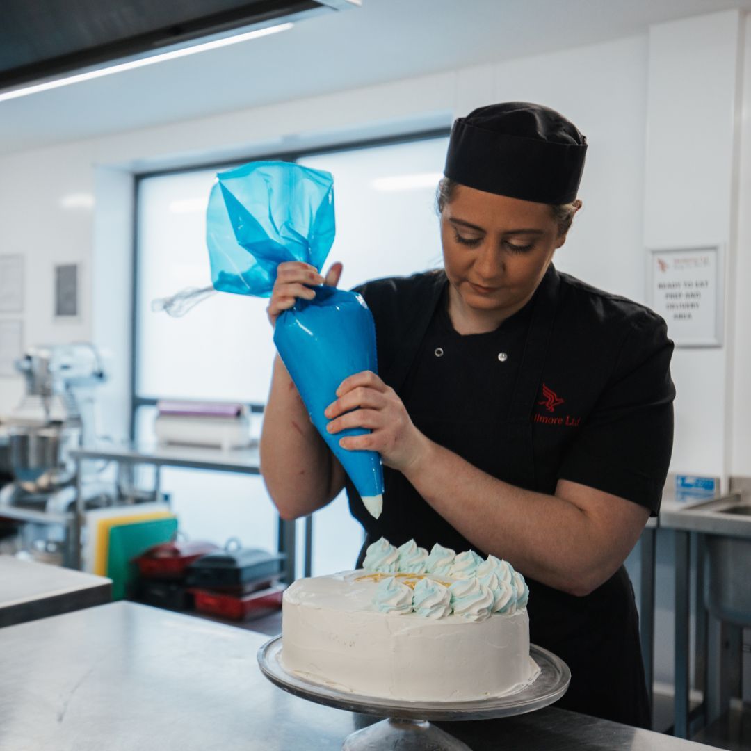A Meallmore chef preparing a freshly plated meal