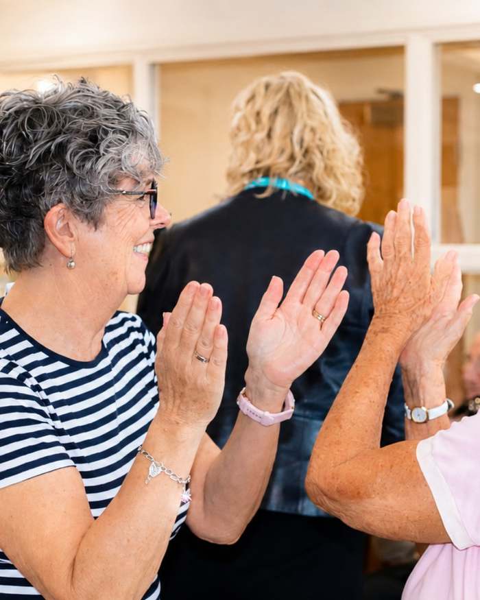 Residents laughing together in the lounge at Mearns House Care Home in Newton Mearns